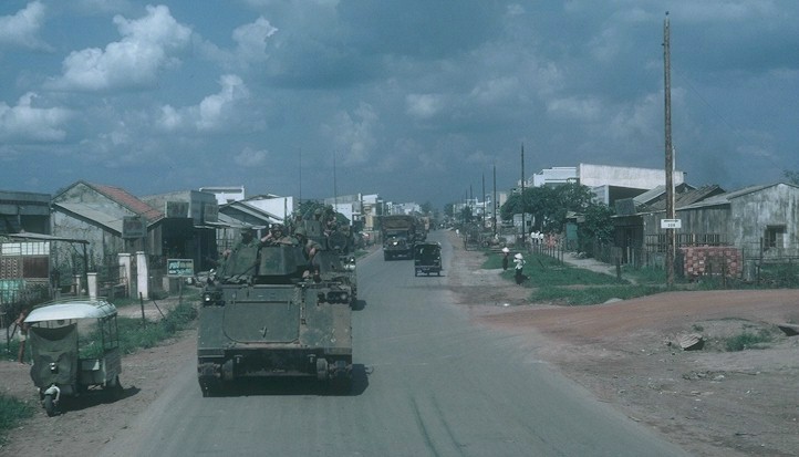 K Troop's convoy passes through a Vietnamese village.
