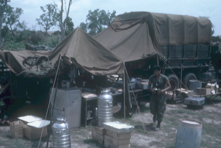 K Troop's cook "Chief" with the troop in the field.